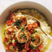 Pesto shrimp with risotto and a fork in a bowl