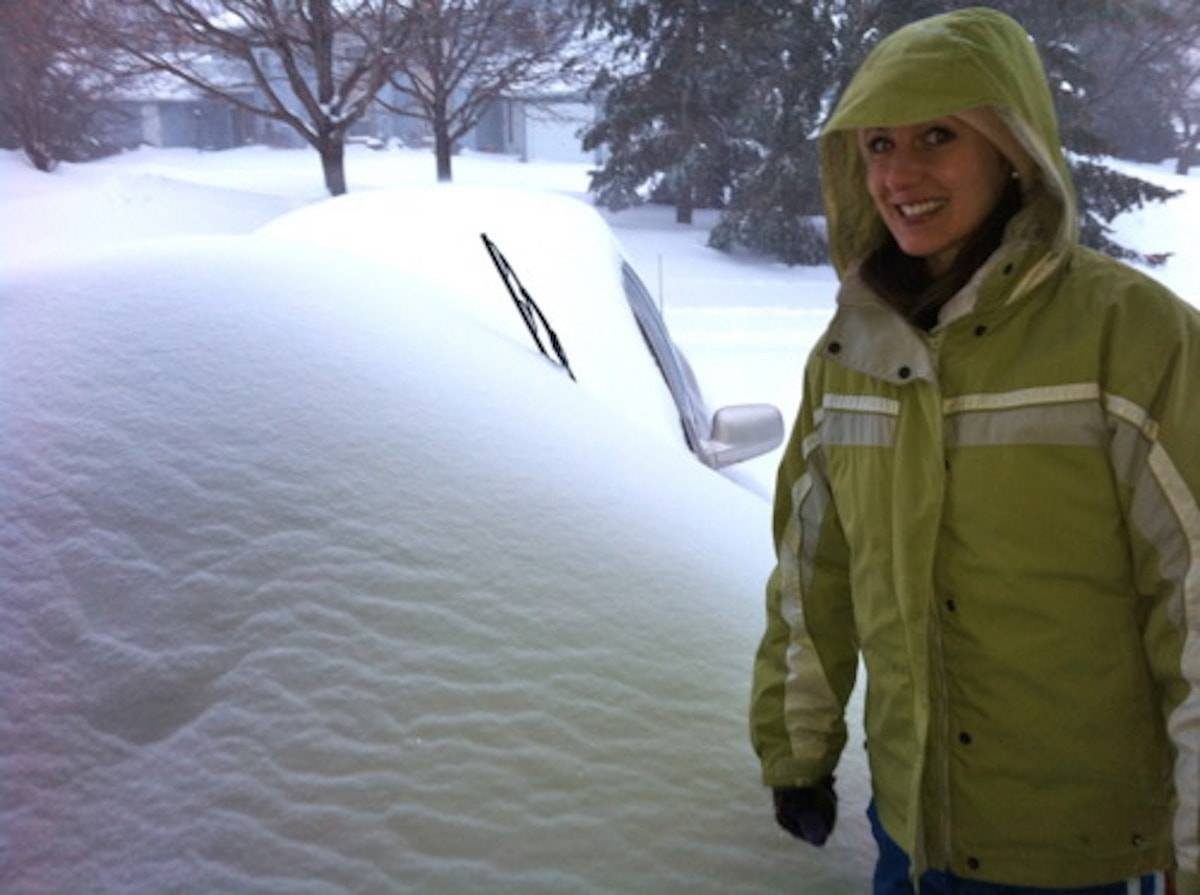 Large sheets of snow covering a car in Minnesota.