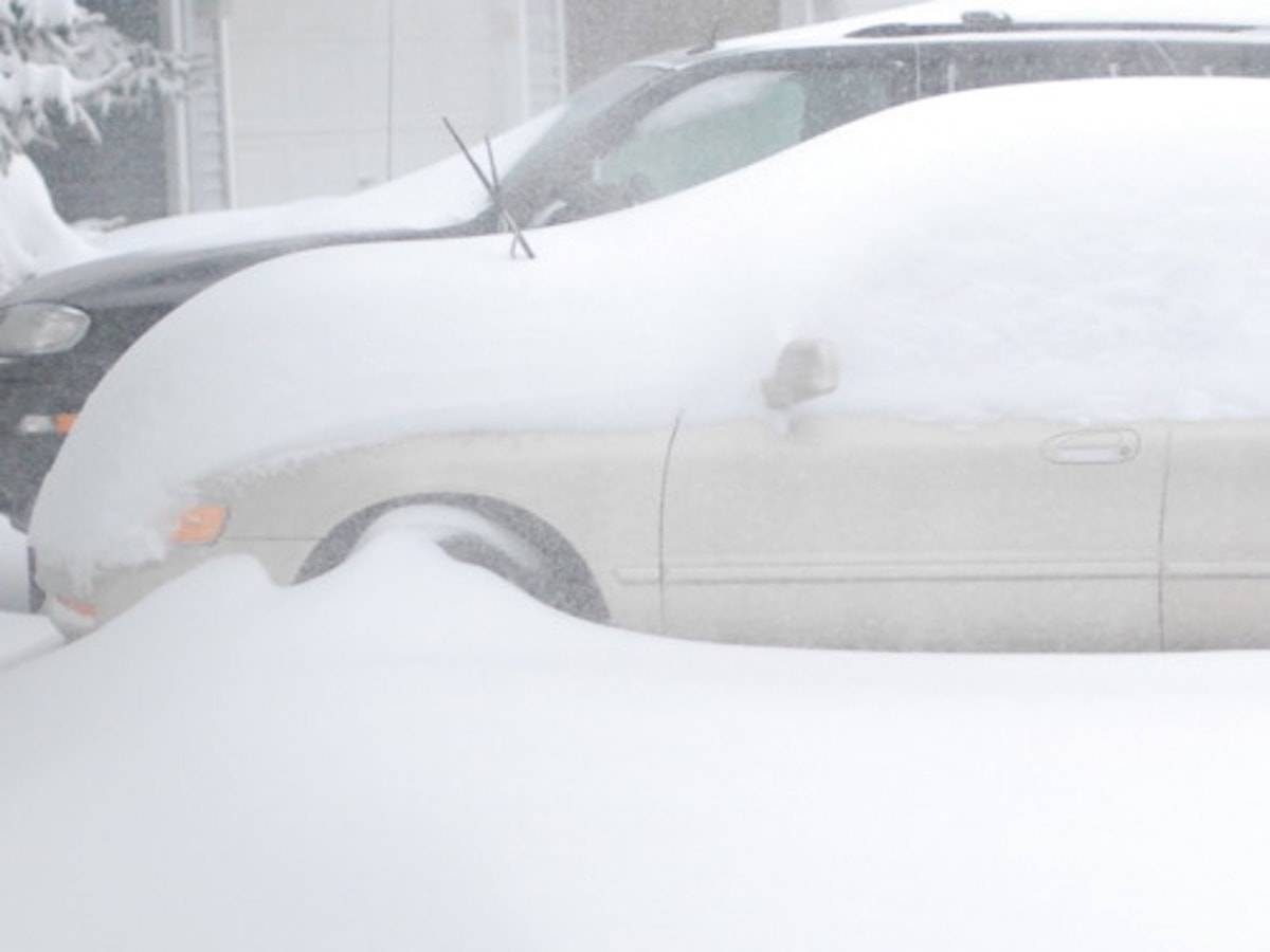 Minnesota Snow covering a tan vehicle.
